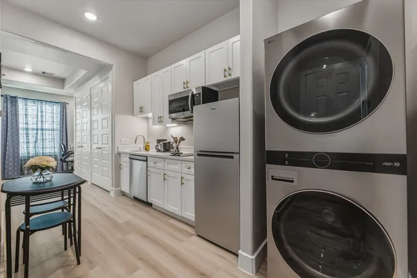 a kitchen with sink cabinets and washer