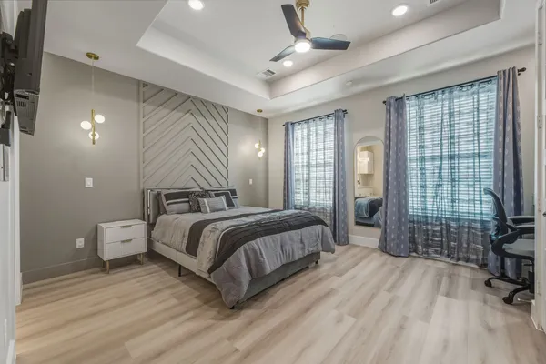 a spacious bedroom with a bed and large windows