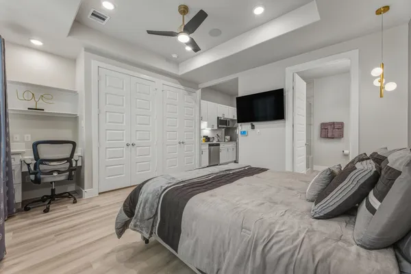 a bedroom with a bed and a flat screen tv