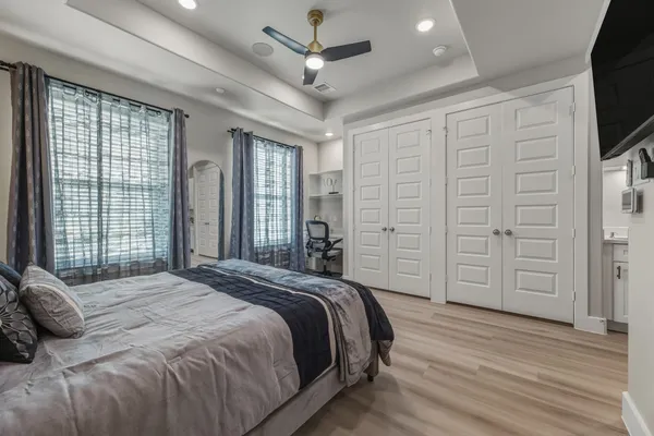 a bedroom with a bed closet and flat tv screen