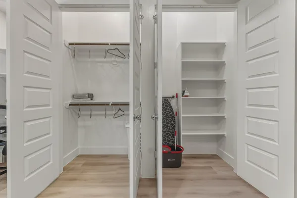 a view of walk in closet with empty racks