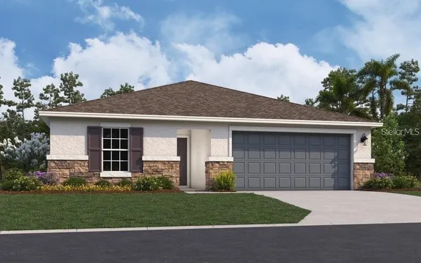 a front view of a house with a garden and yard