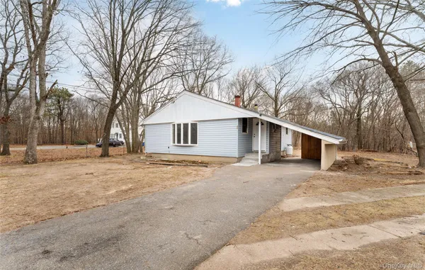 a view of a house with a yard covered in snow