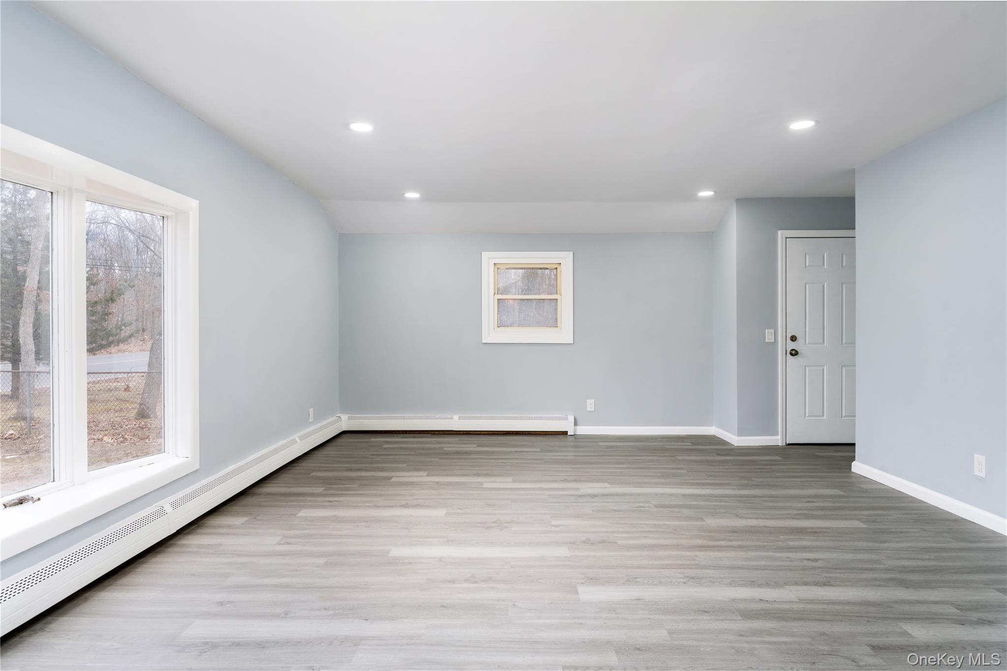 48 Hawkins Road Centereach, NY 11720 - Photo 2 of 22 a view of an empty room with wooden floor and a window