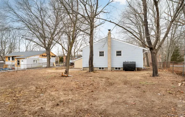 a white house that has a tree in front of it