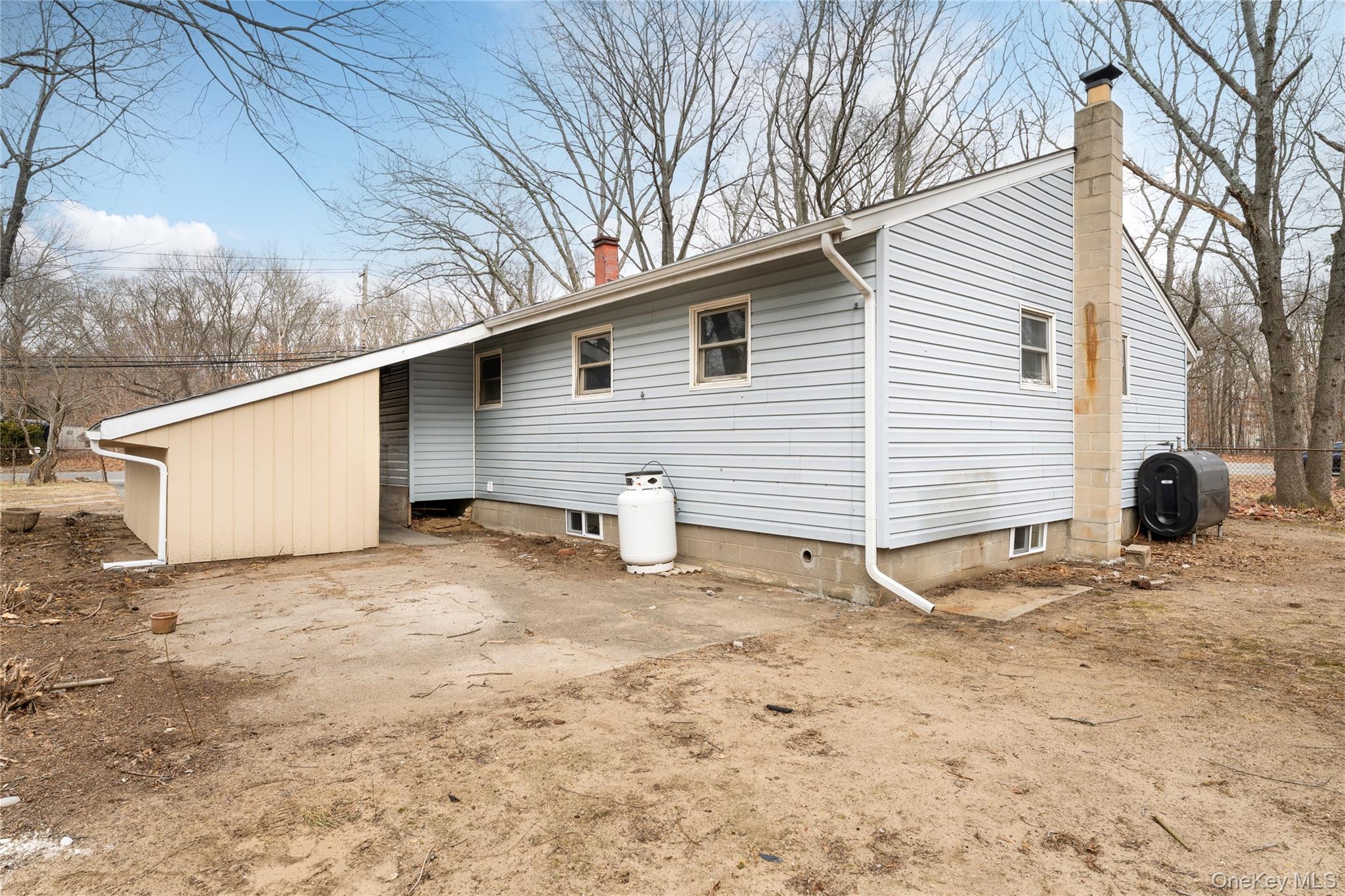 48 Hawkins Road Centereach, NY 11720 - Photo 22 of 22 a view of a white house with a yard and large tree
