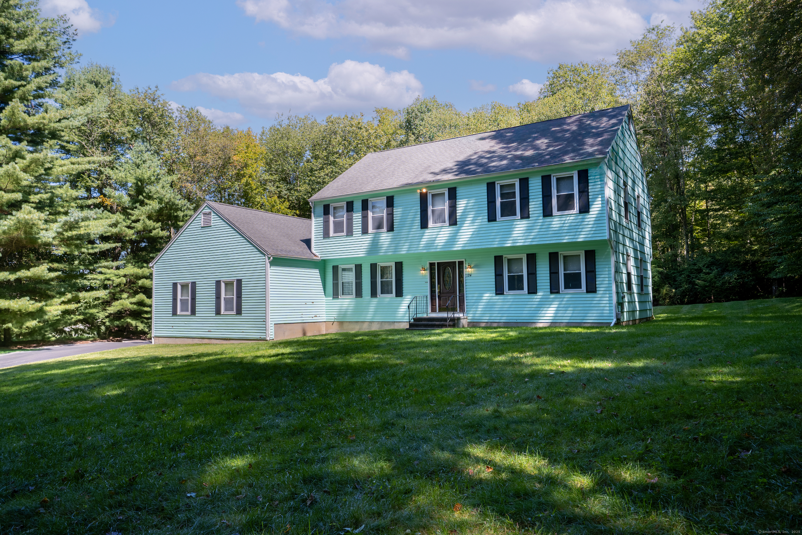 a front view of a house with a garden