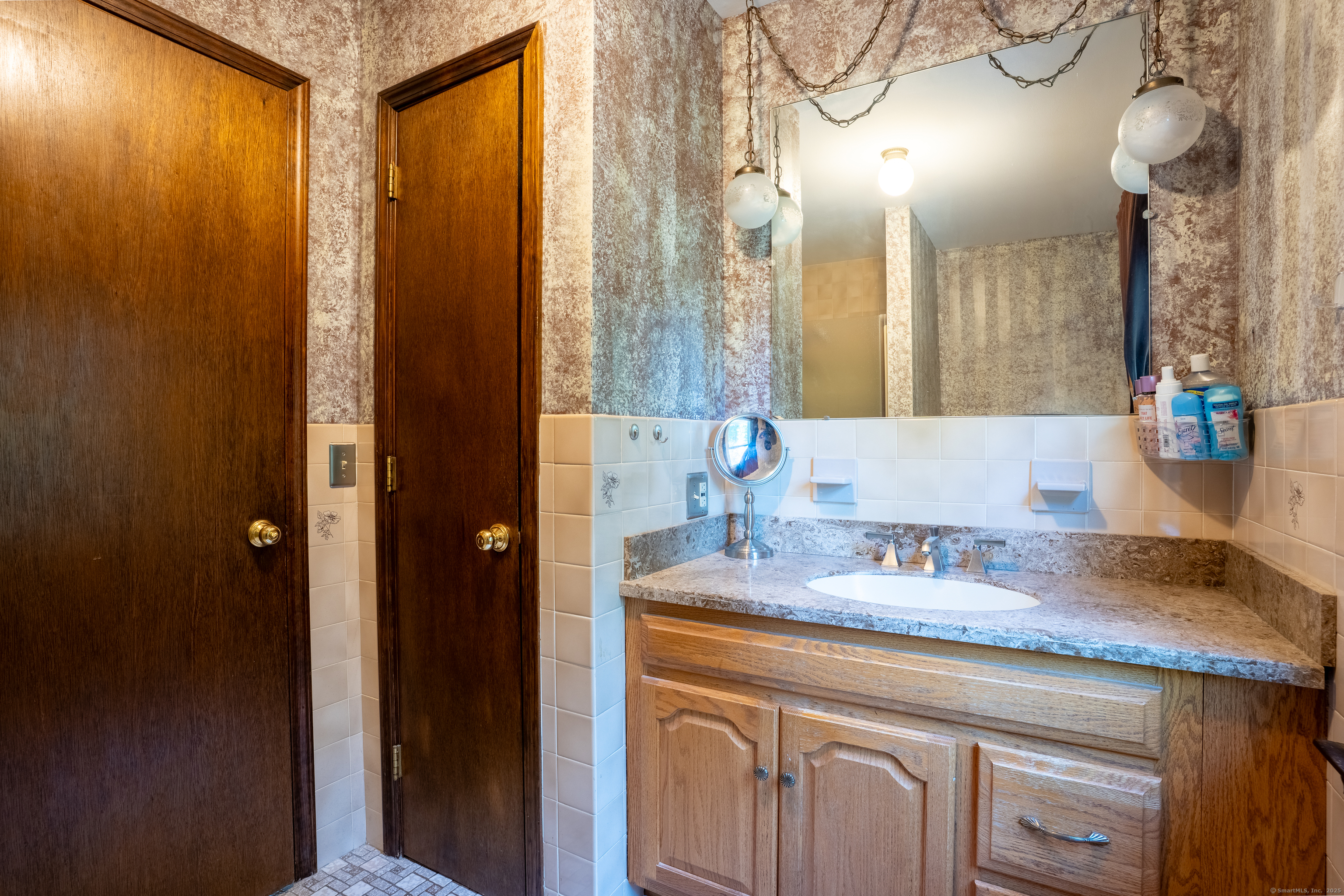 124 Bagburn Hill Road Monroe, CT 06468 - Photo 18 of 34 a bathroom with double vanity and a mirror