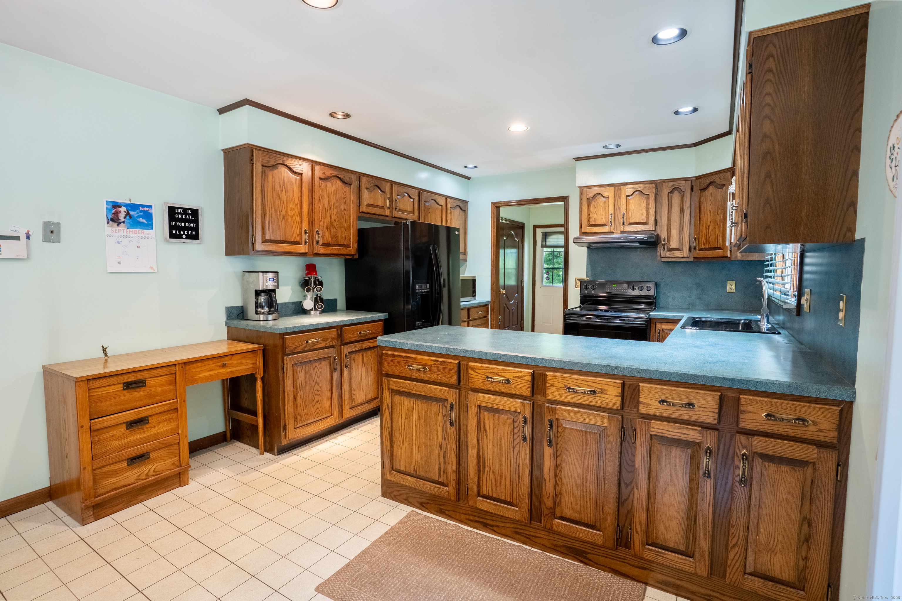 124 Bagburn Hill Road Monroe, CT 06468 - Photo 4 of 34 a kitchen with stainless steel appliances granite countertop a stove a sink and a refrigerator