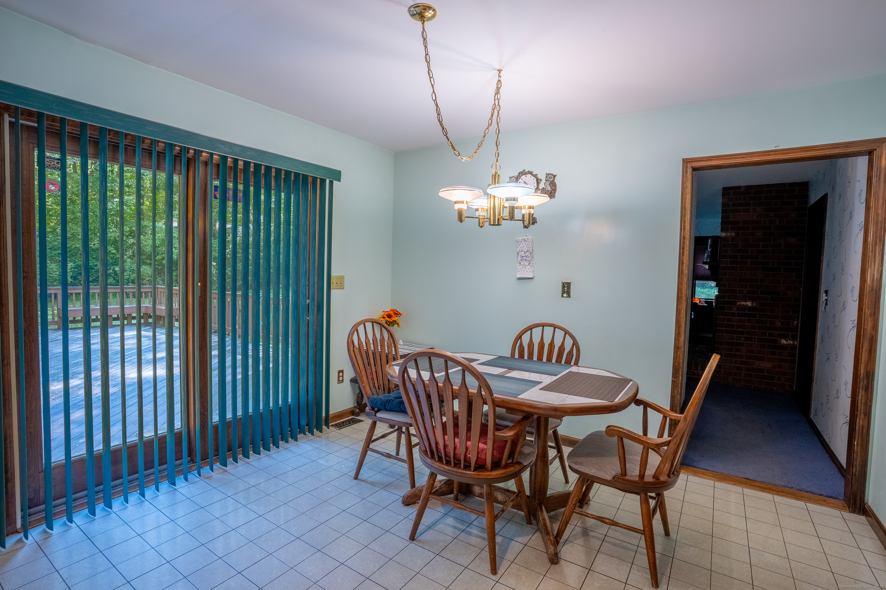 124 Bagburn Hill Road Monroe, CT 06468 - Photo 6 of 34 a dining room with furniture a rug and a chandelier