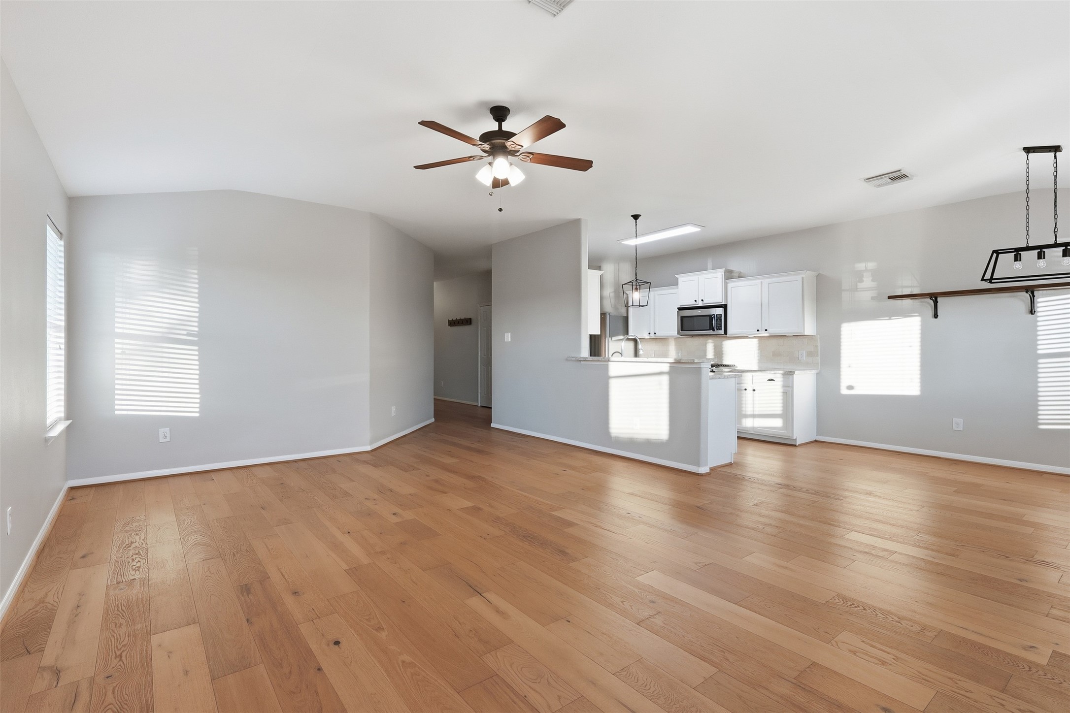 6006 Wilcox Point Drive Spring, TX 77388 - Photo 12 of 30 a view of a kitchen with a dishwasher a kitchen island hardwood floor and a window