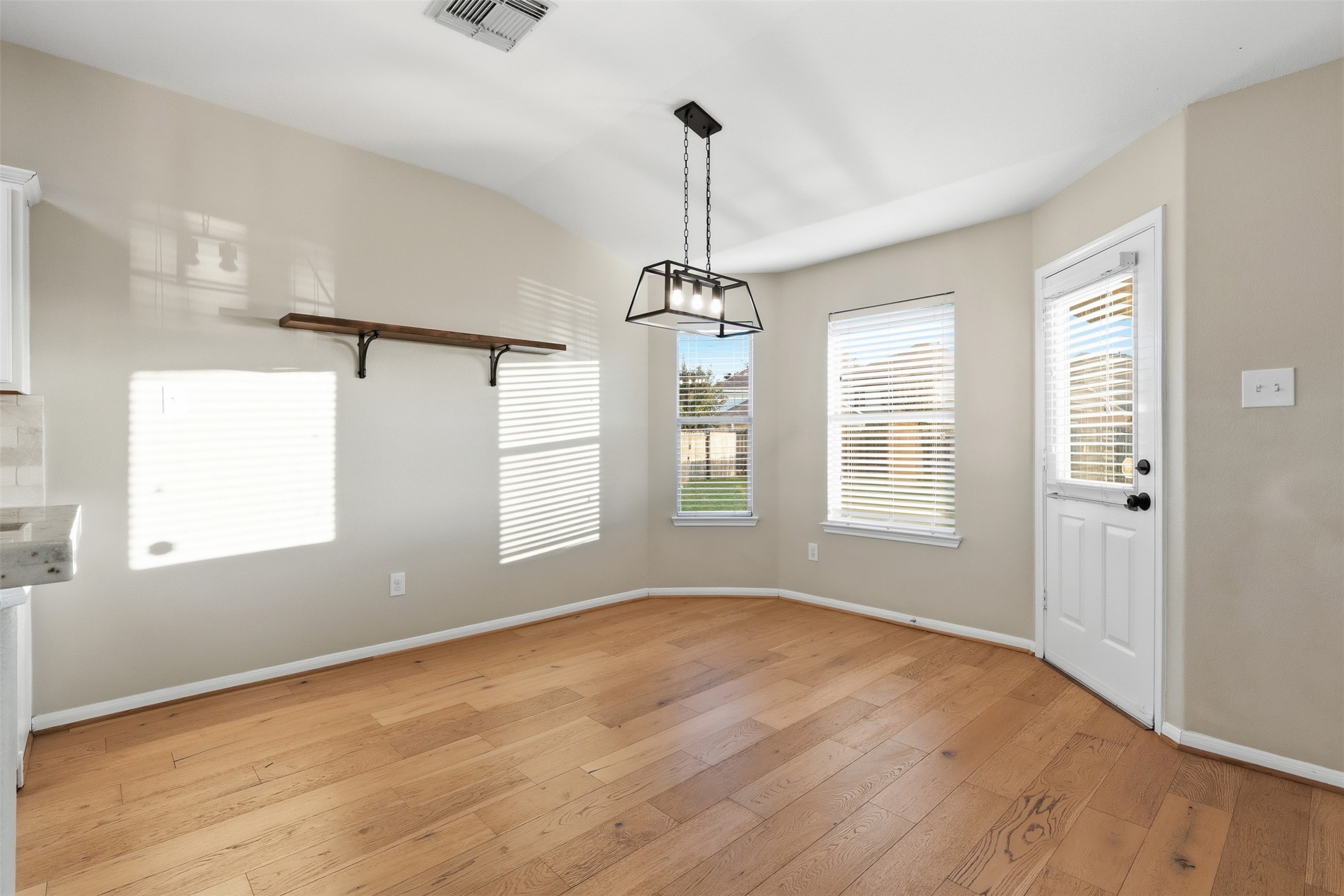 6006 Wilcox Point Drive Spring, TX 77388 - Photo 14 of 30 a view of a room with window wooden floor and chandelier