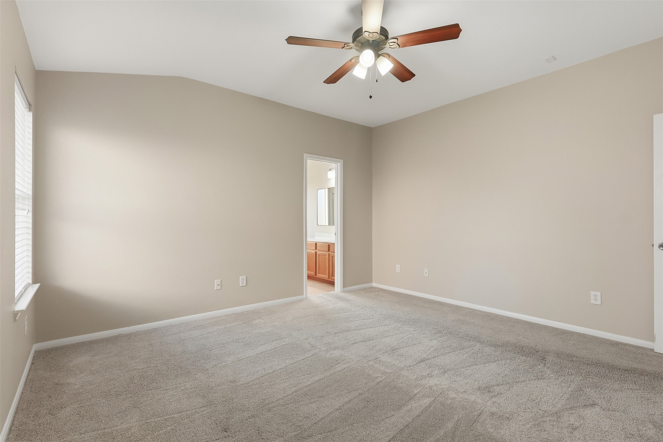 6006 Wilcox Point Drive Spring, TX 77388 - Photo 21 of 30 an empty room with a chandelier fan and windows