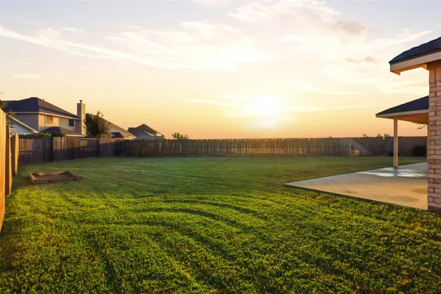 a view of a house with yard and a street view