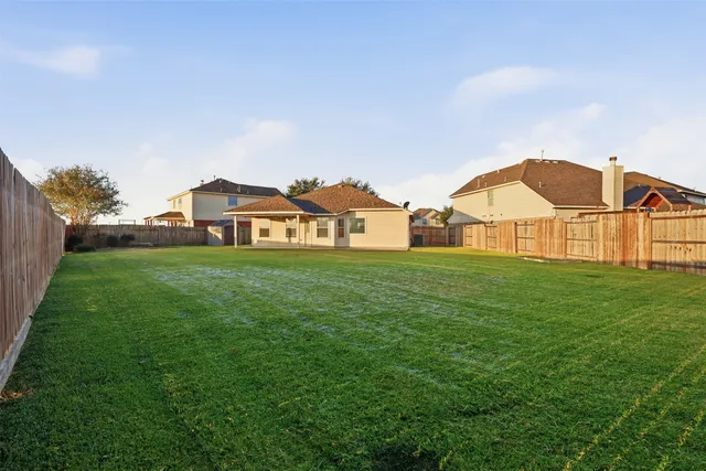 a view of a house with a small yard and table and chairs