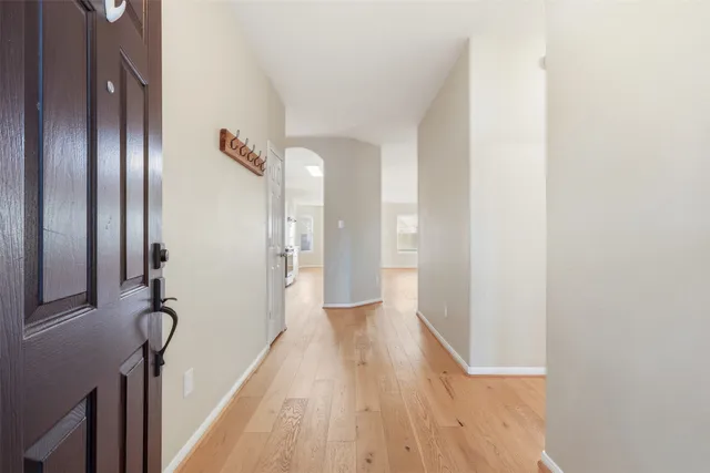 a view of a hallway with wooden floor