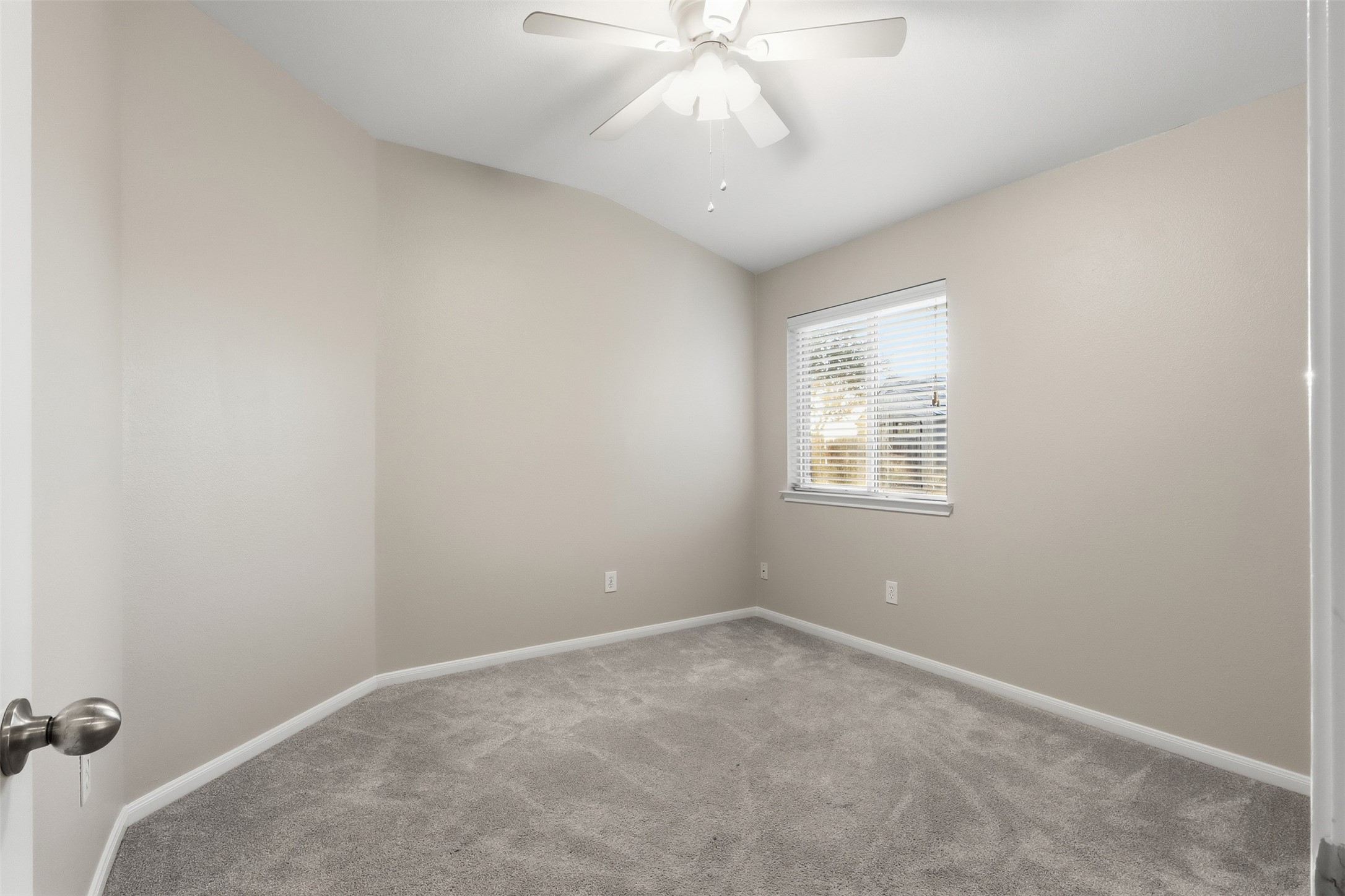 6006 Wilcox Point Drive Spring, TX 77388 - Photo 7 of 30 an empty room with a chandelier fan and windows