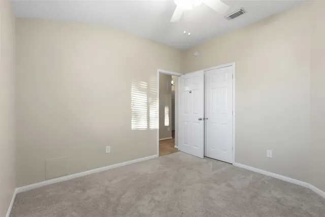 an empty room with an entryway and window