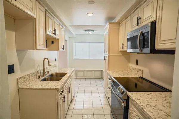 a kitchen that has a sink and a stove
