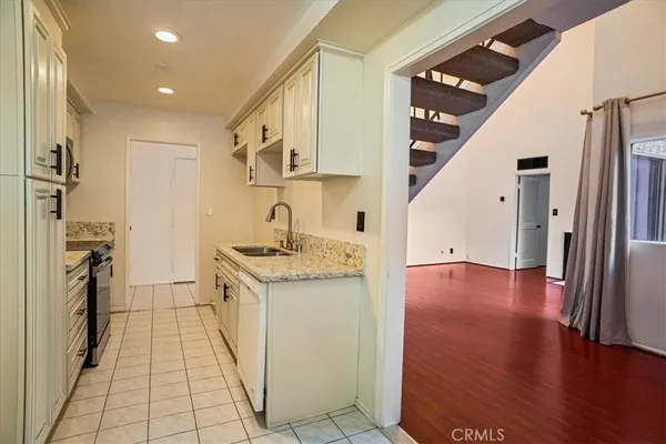 a kitchen with stainless steel appliances granite countertop a refrigerator and a stove