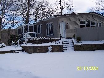 45 Sylvan Road Monterey, MA 01245 - Photo 1 of 1 a view of house with yard outdoor seating and covered with tall trees