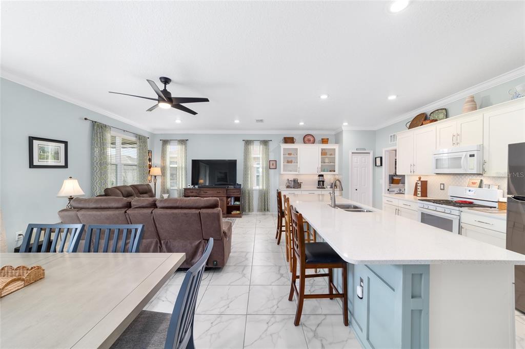 7765 Southwest 80th Pl Road Ocala, FL 34476 - Photo 20 of 37 a large kitchen with a table and chairs