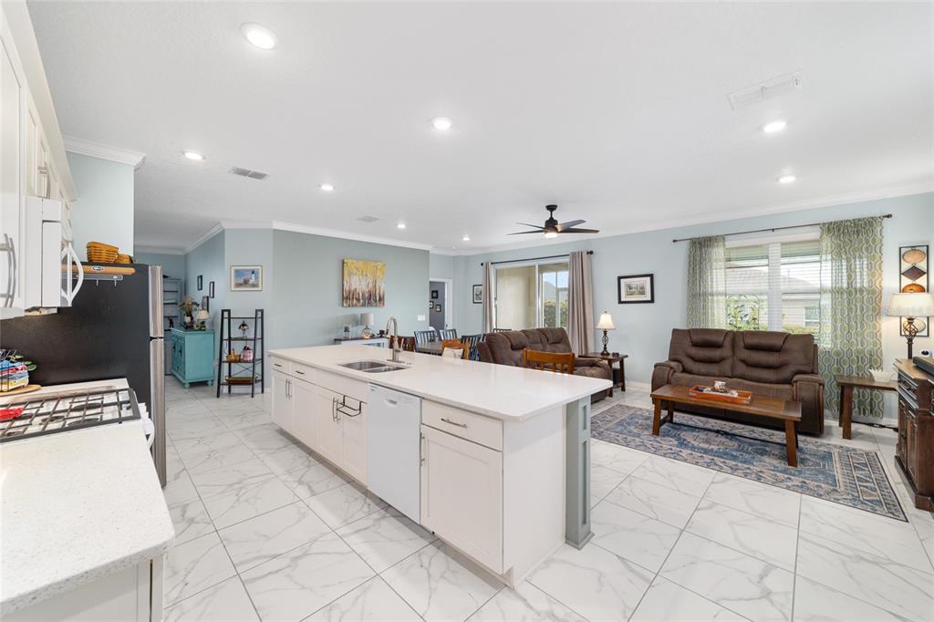 7765 Southwest 80th Pl Road Ocala, FL 34476 - Photo 22 of 37 a large white kitchen with a large window and cabinets