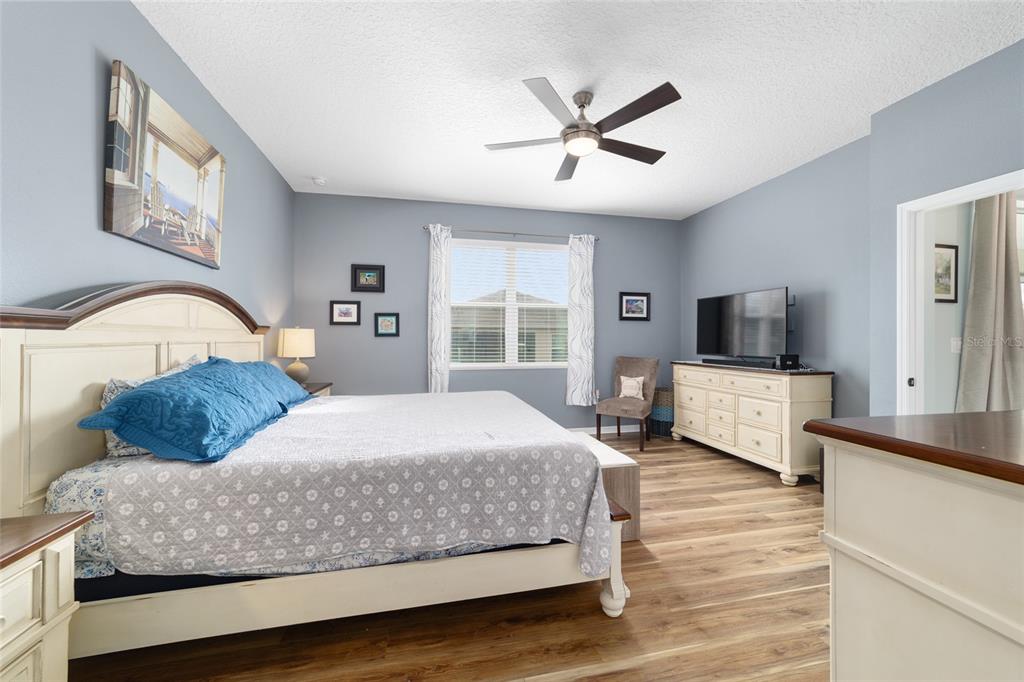 7765 Southwest 80th Pl Road Ocala, FL 34476 - Photo 25 of 37 a bedroom with a large bed and a flat screen tv