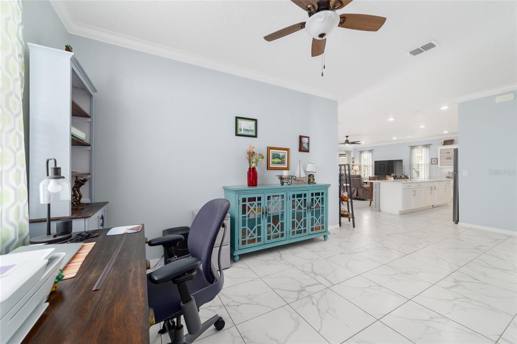 7765 Southwest 80th Pl Road Ocala, FL 34476 - Photo 28 of 37 a living room with furniture and kitchen view