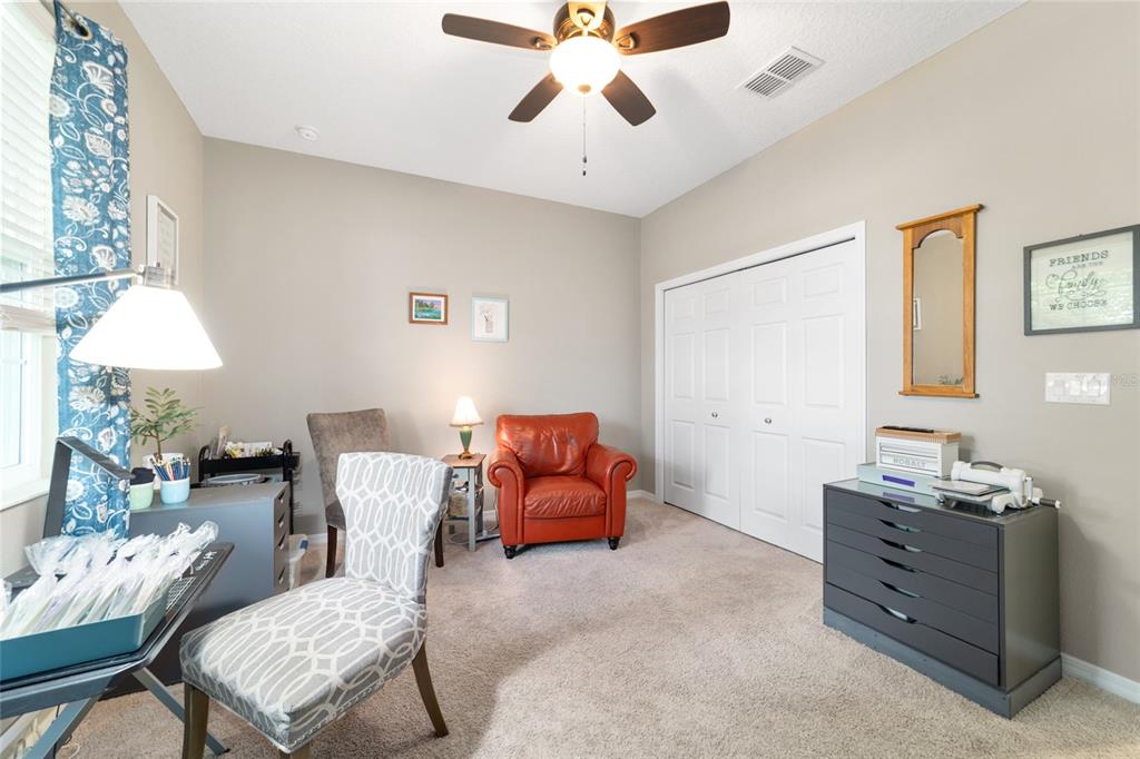 7765 Southwest 80th Pl Road Ocala, FL 34476 - Photo 30 of 37 a living room with furniture and a chandelier