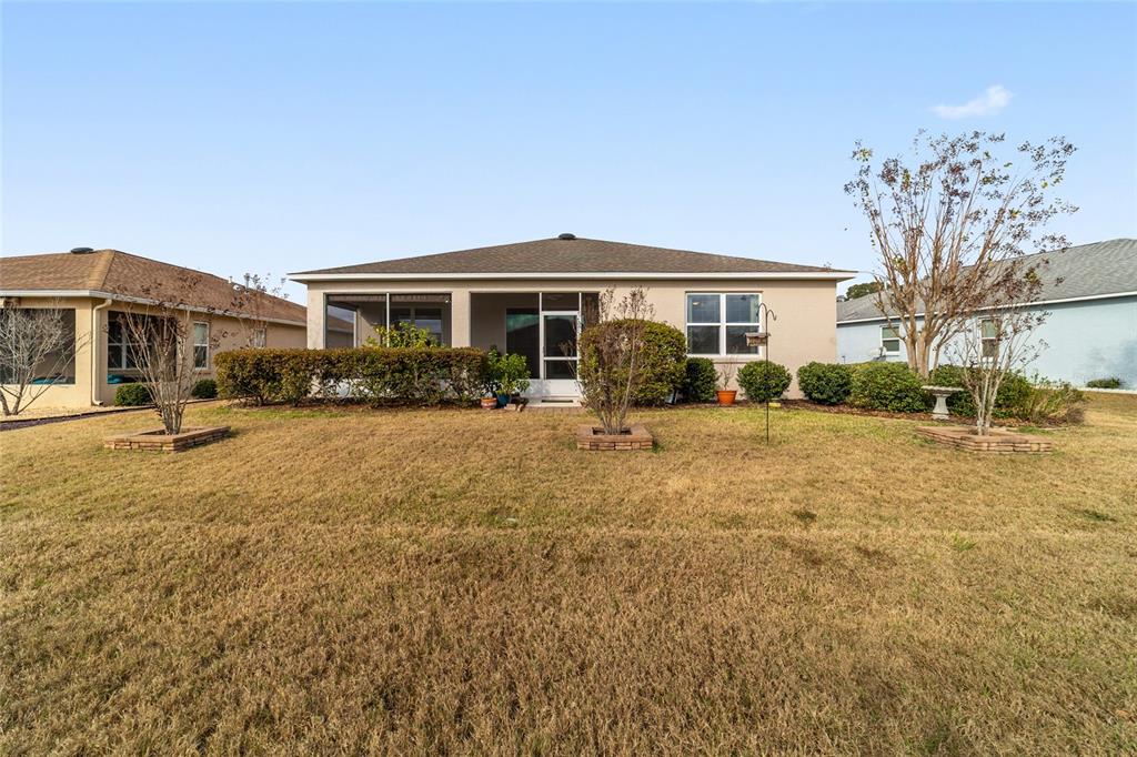 7765 Southwest 80th Pl Road Ocala, FL 34476 - Photo 36 of 37 a front view of a house with a yard