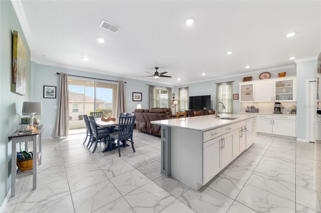 7765 Southwest 80th Pl Road Ocala, FL 34476 - Photo 8 of 37 a large white kitchen with cabinets and chairs