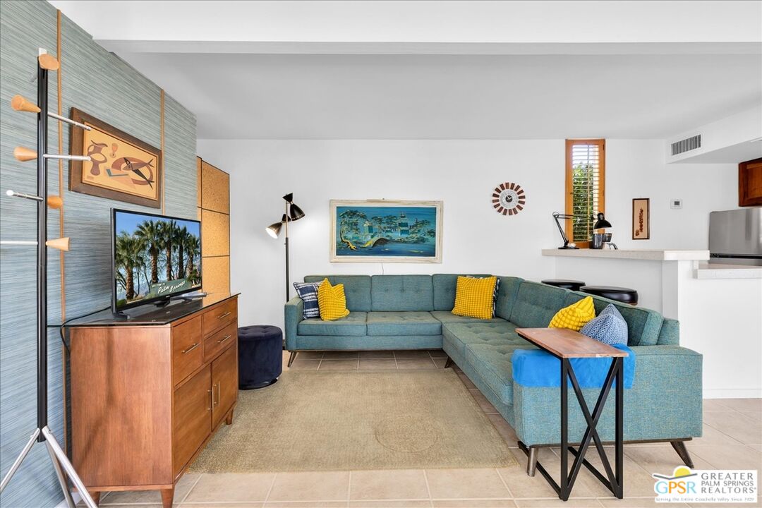 360 Cabrillo Road, Unit 220 Palm Springs, CA 92262 - Photo 12 of 57 a living room with furniture and a flat screen tv