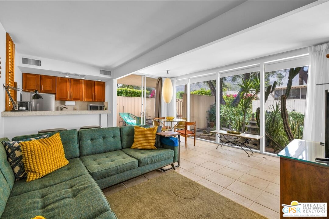 360 Cabrillo Road, Unit 220 Palm Springs, CA 92262 - Photo 13 of 57 a living room with furniture and floor to ceiling windows