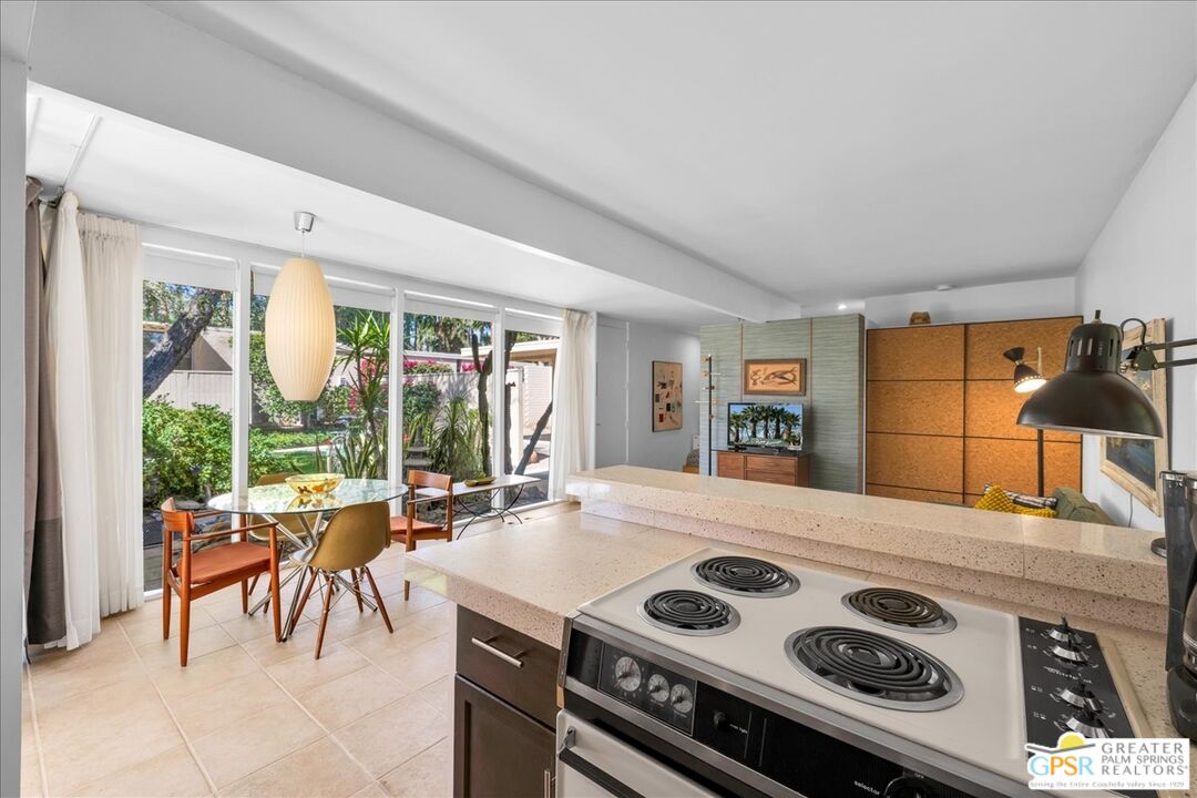 360 Cabrillo Road, Unit 220 Palm Springs, CA 92262 - Photo 22 of 57 a kitchen with a stove and a refrigerator
