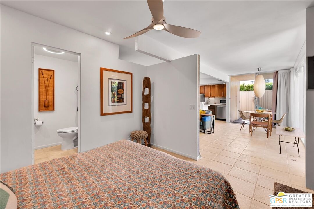 360 Cabrillo Road, Unit 220 Palm Springs, CA 92262 - Photo 25 of 57 a bedroom with a bed a table and chair