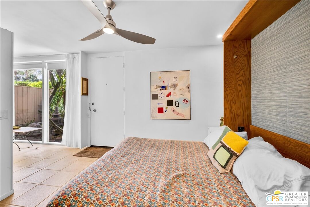 360 Cabrillo Road, Unit 220 Palm Springs, CA 92262 - Photo 27 of 57 a bedroom with a bed and a painting on the wall