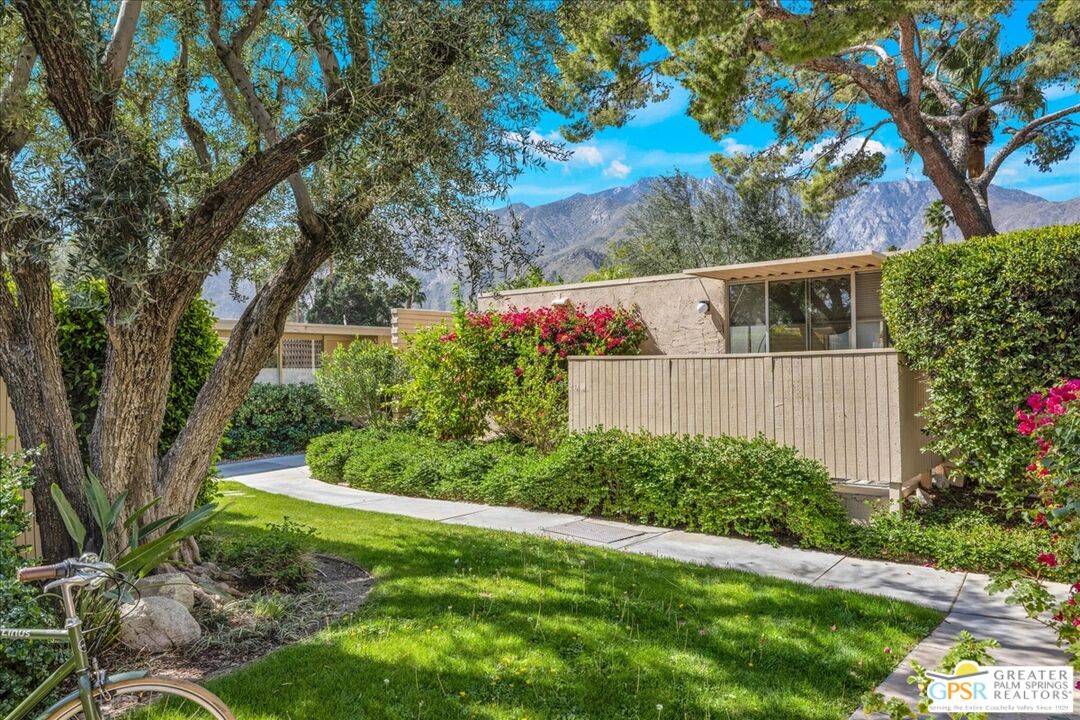 360 Cabrillo Road, Unit 220 Palm Springs, CA 92262 - Photo 8 of 57 a backyard of a house with lots of green space and garden view
