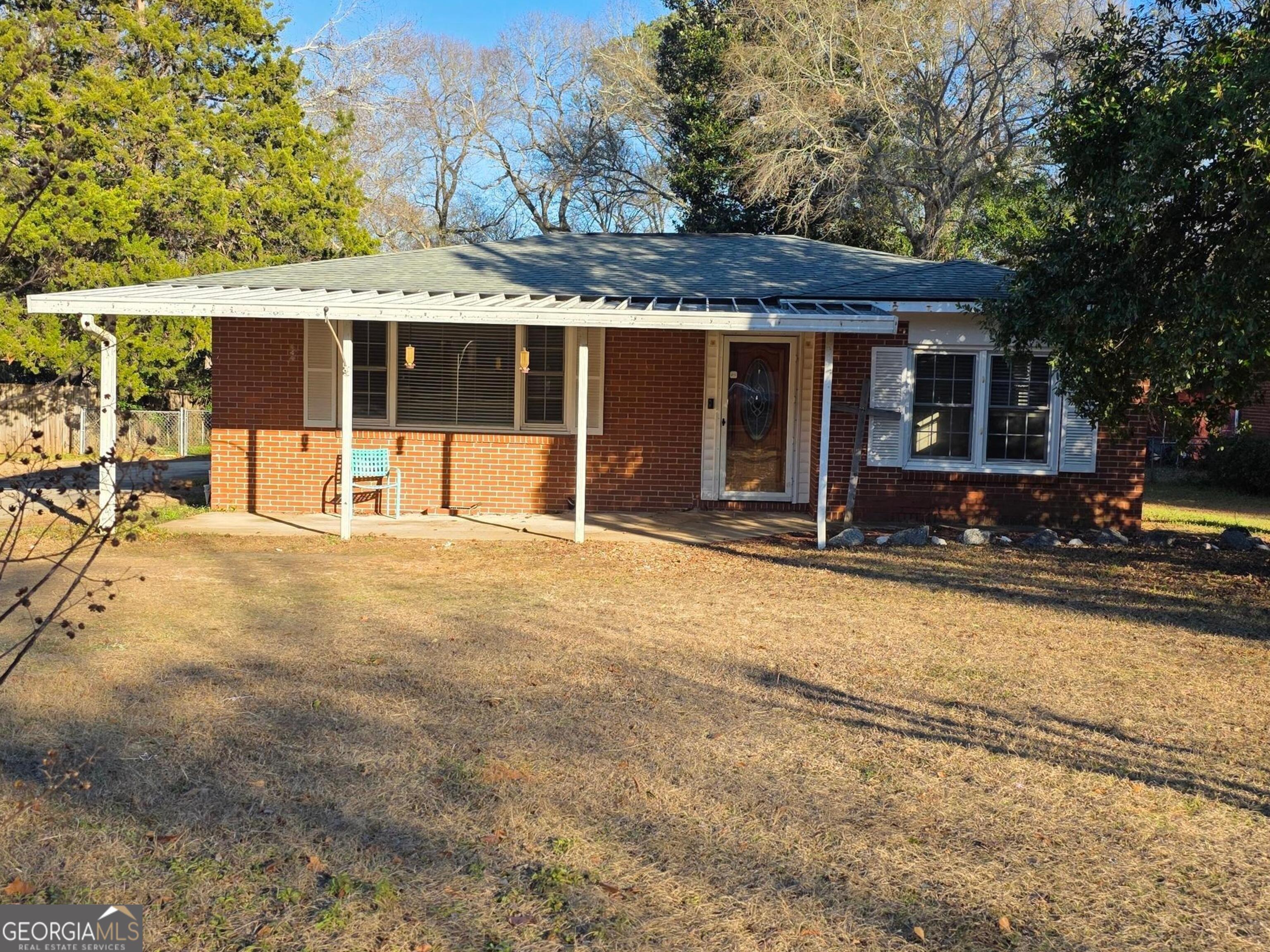 a front view of a house with a yard outdoor seating and garage