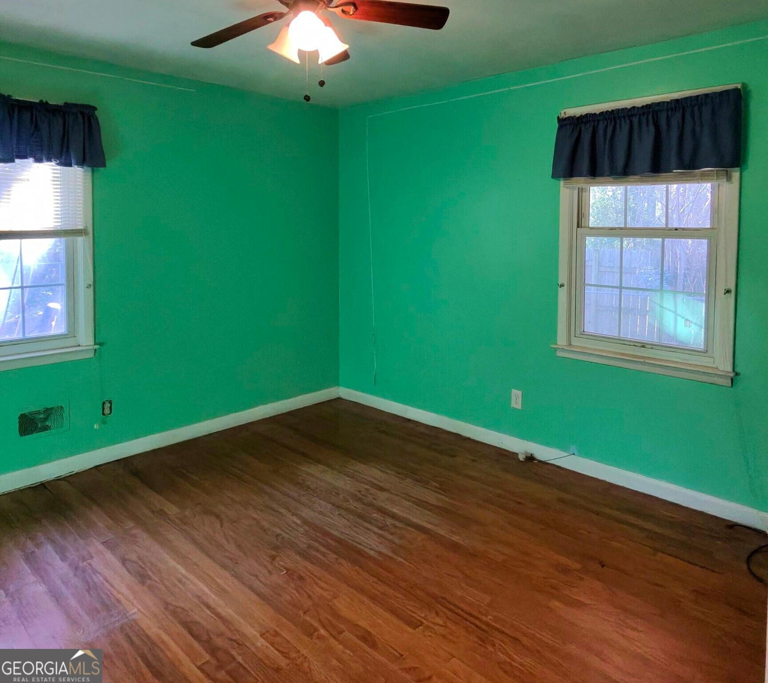 110 Lee Street Centerville, GA 31028 - Photo 12 of 18 an empty room with wooden floor and windows