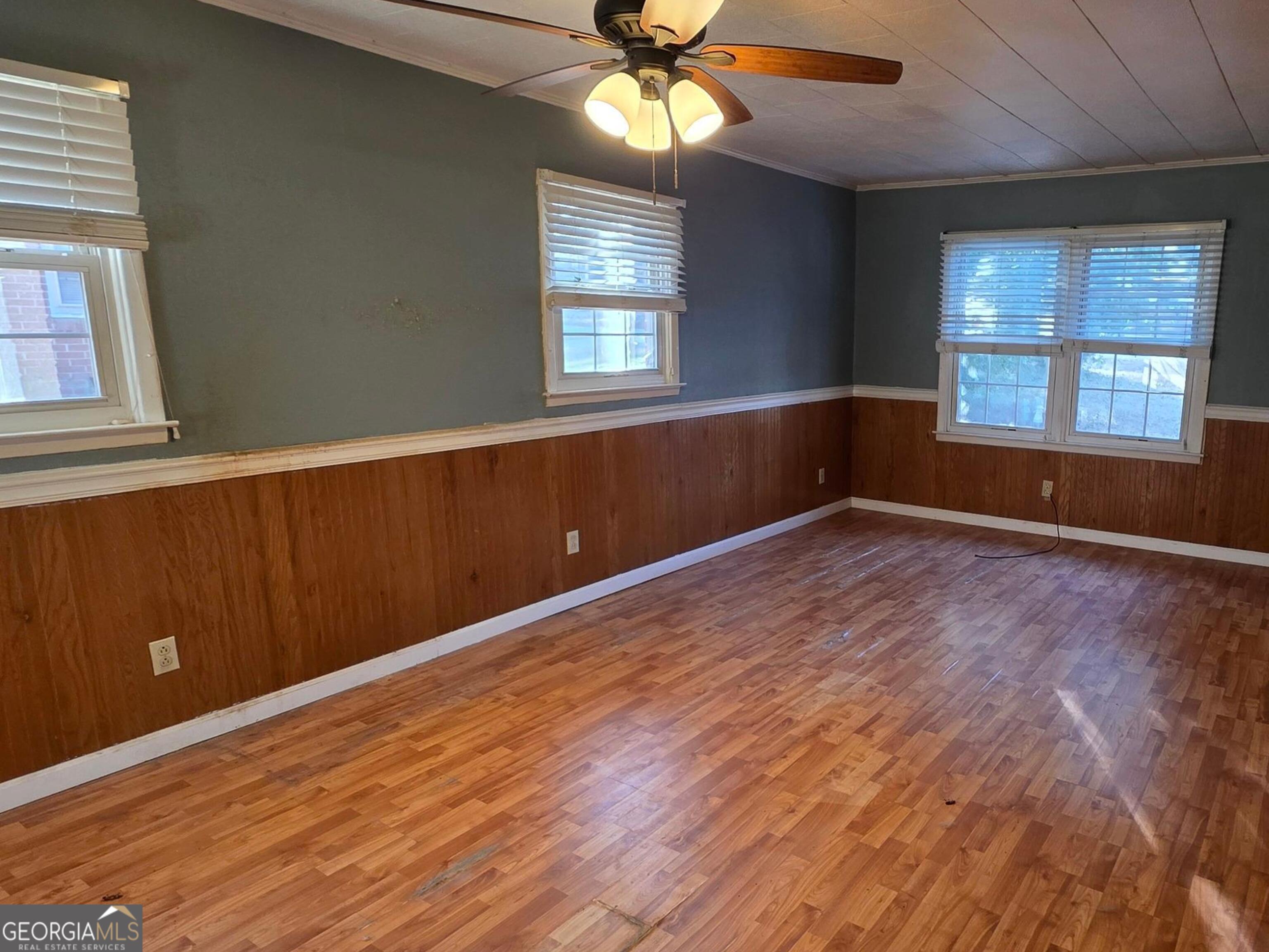 110 Lee Street Centerville, GA 31028 - Photo 5 of 18 wooden floor in an empty room with a window