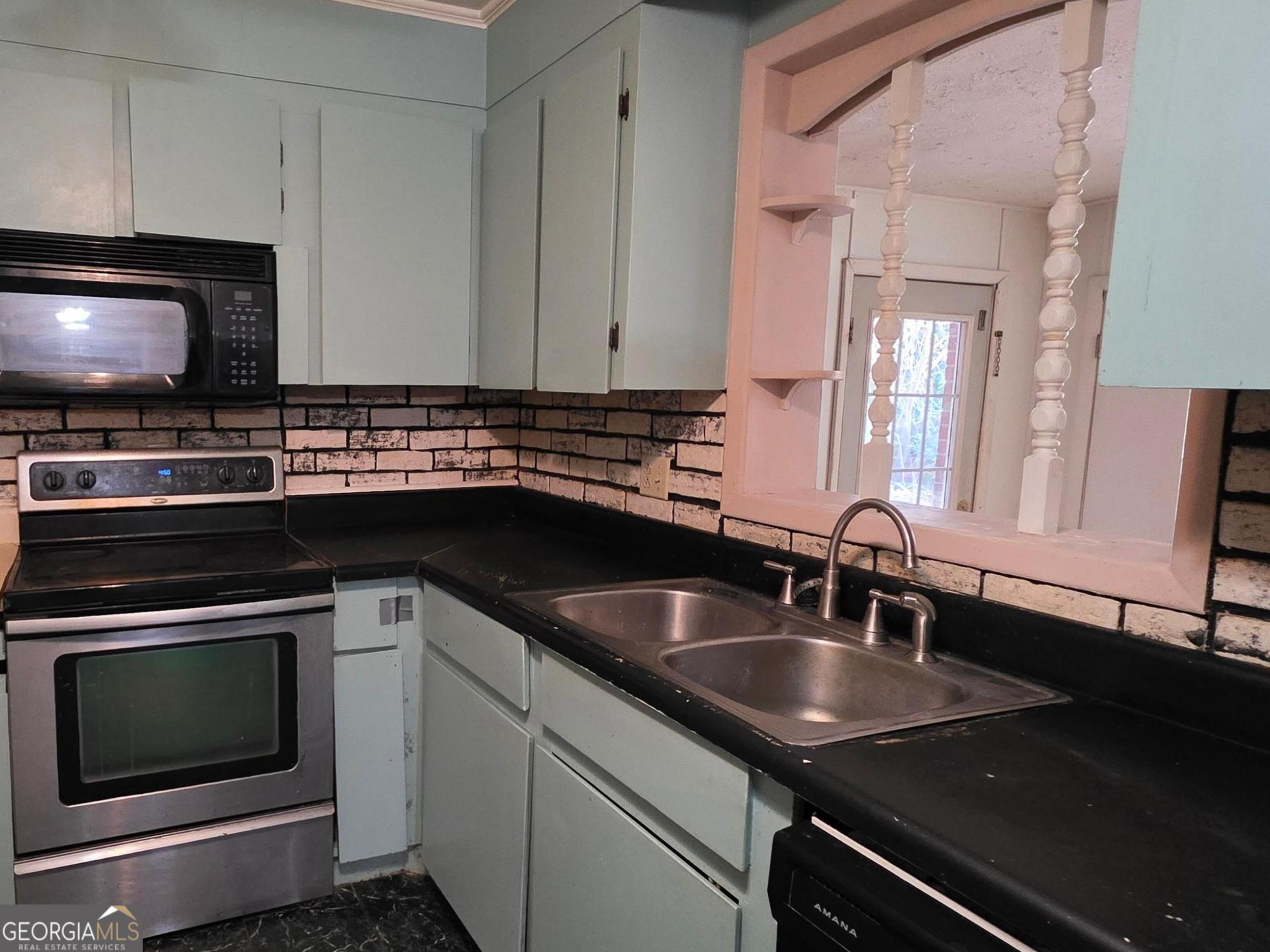 110 Lee Street Centerville, GA 31028 - Photo 7 of 18 a kitchen with a sink stove and microwave