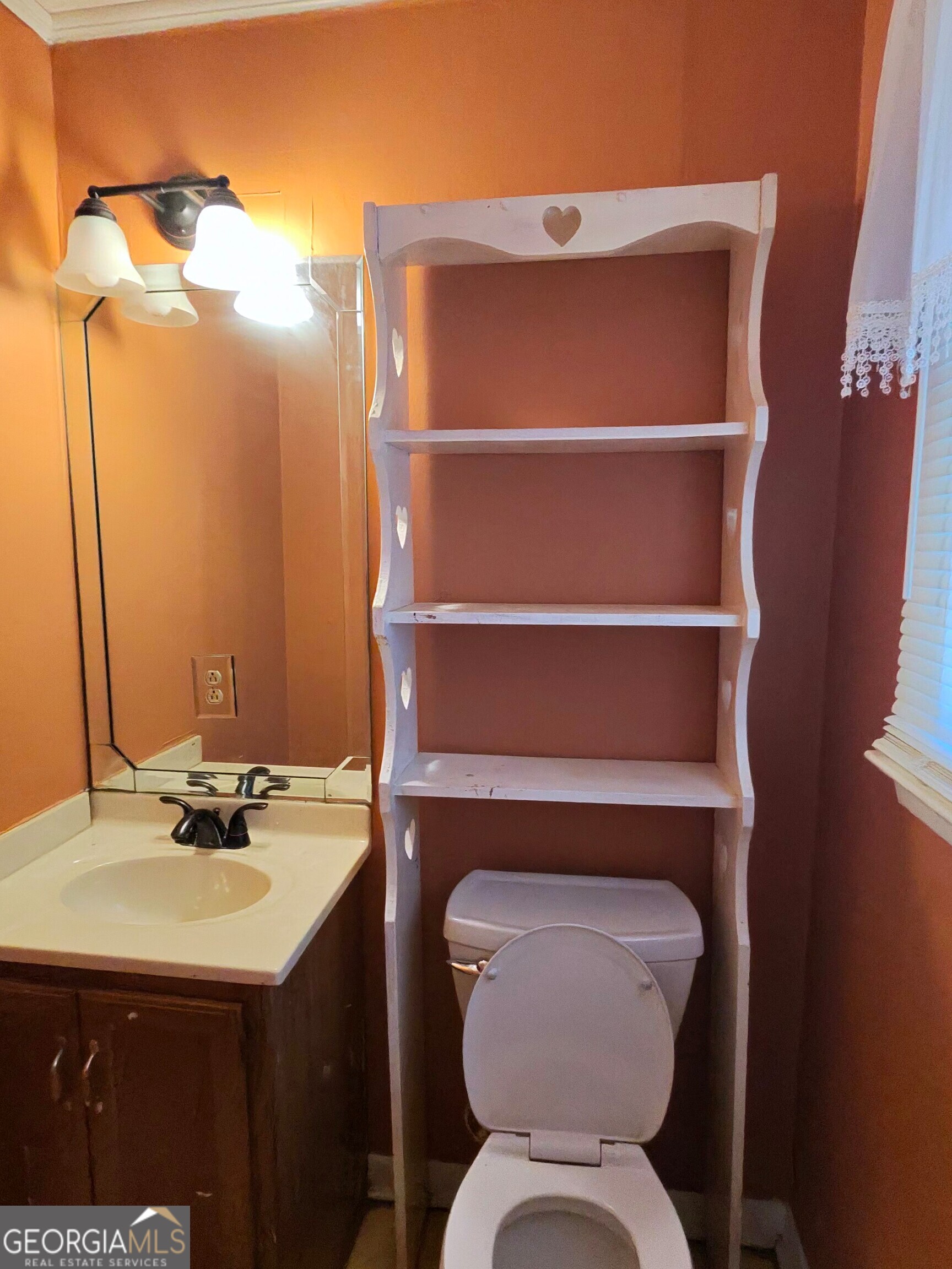 110 Lee Street Centerville, GA 31028 - Photo 10 of 18 a bathroom with a toilet sink and mirror