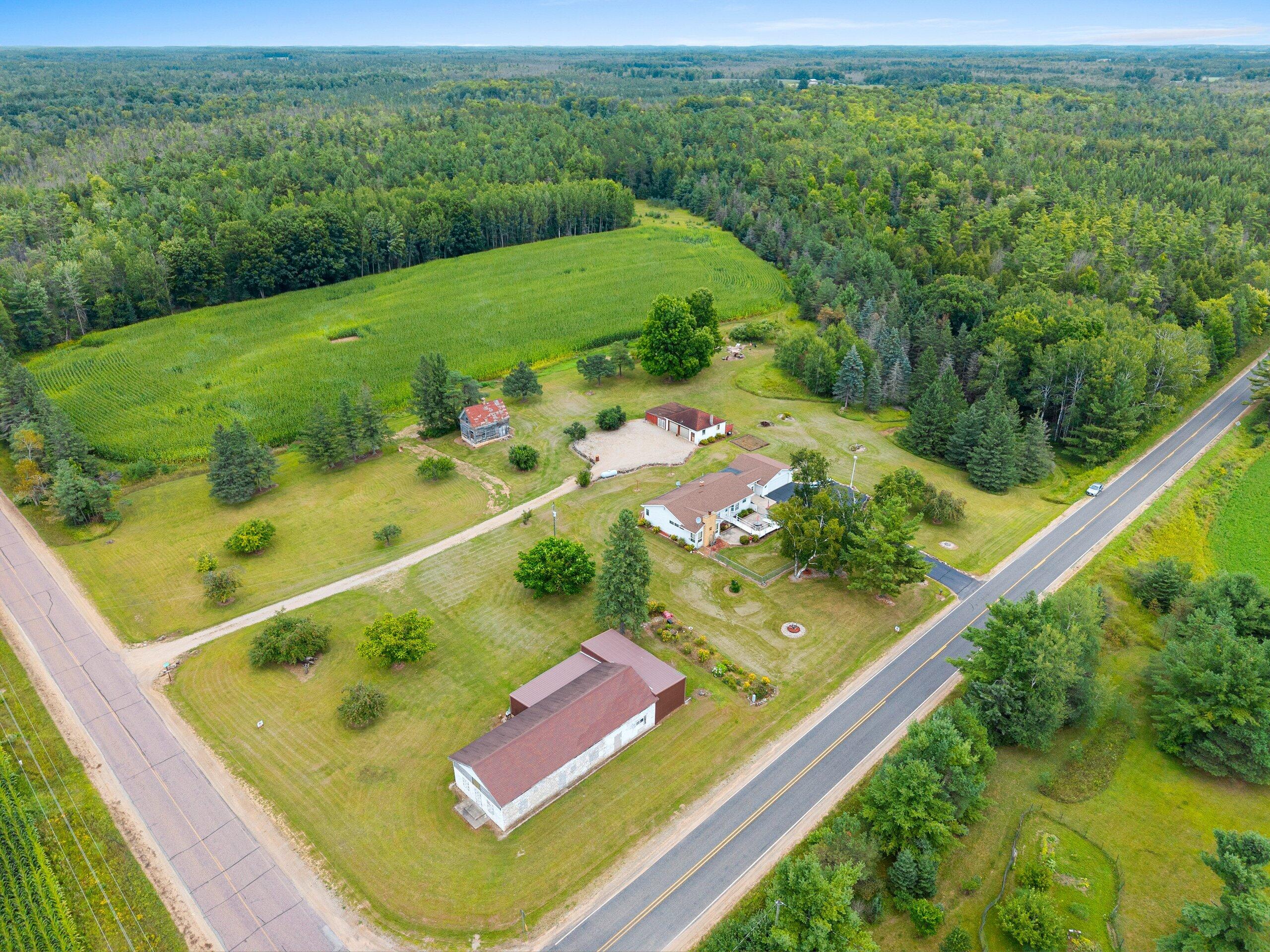W7478 County Road 358 Daggett, MI 49821 - Photo 60 of 70 Aerial layout of home, barn on corner, 2nd garage in back and old homestead. Corn field is lease currently, woods are all part of this