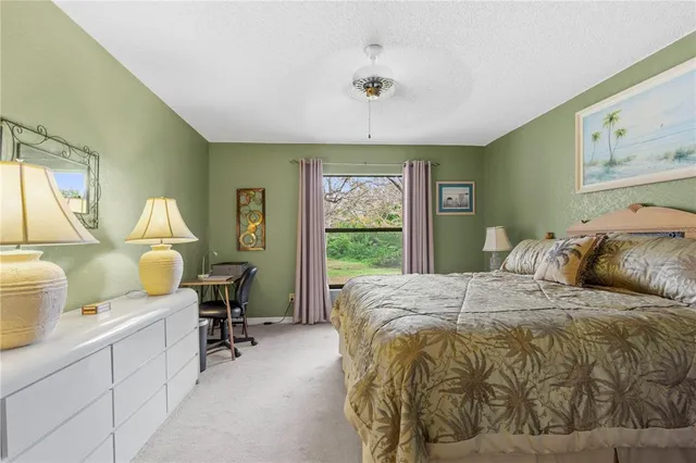 a bed room with a bed and a chair