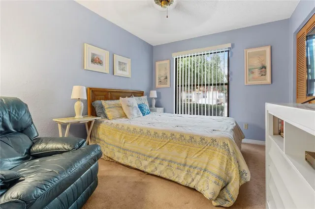 a bed sitting in a bedroom next to a window