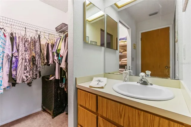a bathroom with a sink mirror and shower