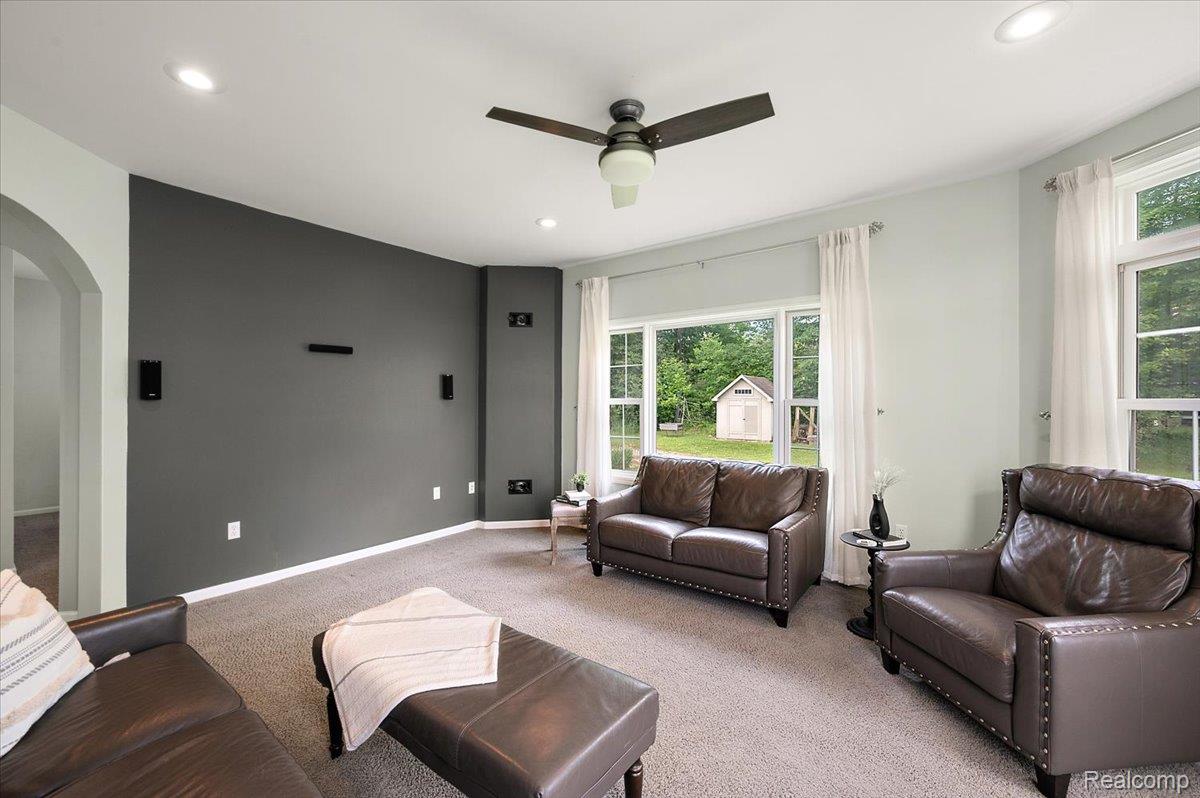5035 Hidden Ridge Road Metamora, MI 48455 - Photo 6 of 62 Carpeted living area featuring a dark accent wall, recessed lighting, and a ceiling fan