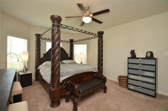 a bedroom with bed and a chandelier