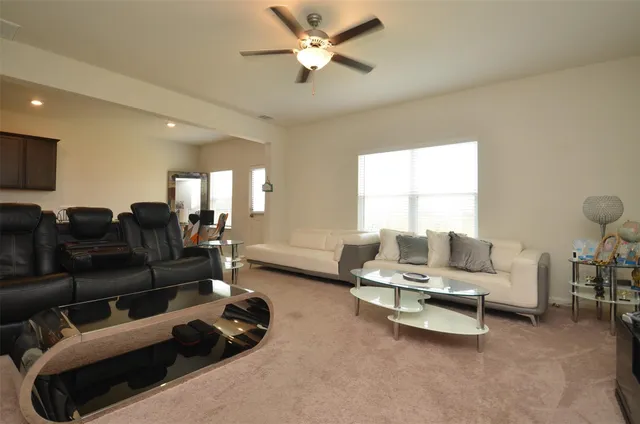 a living room with furniture and a large window